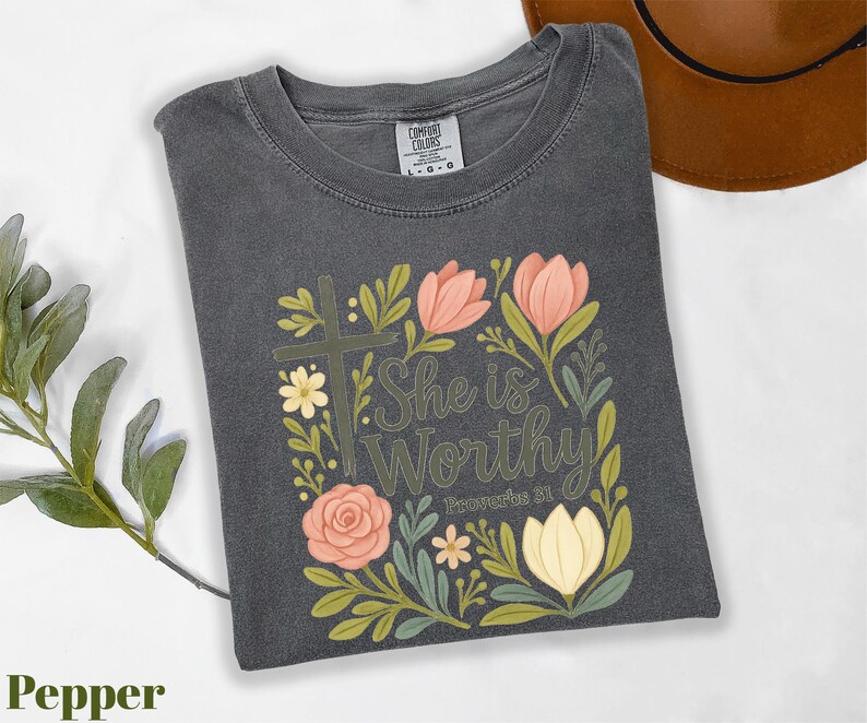a t - shirt with the words she is worthy on it