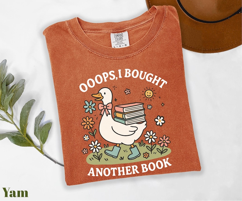a t - shirt with a picture of a duck reading a book