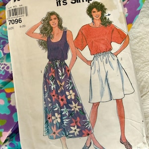 May include: Vintage Simplicity sewing pattern. The pattern features illustrations of two women's outfits: a floral skirt with a tank top and shorts with a short-sleeved top. Pattern number 7096, size 8-20.