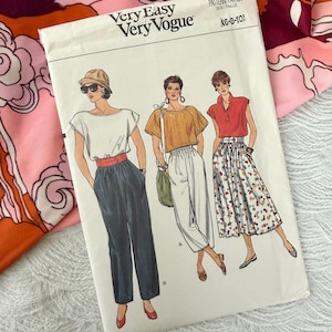 May include: A vintage sewing pattern titled "Very Easy Very Vogue" with illustrations of three women in different outfits. The pattern number is 9303, and the size range is (6-8-10). The background includes a floral patterned fabric.