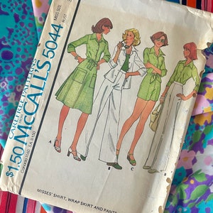 May include: Vintage sewing pattern McCall's 5044 for a misses' shirt, wrap skirt and pants or shorts. The pattern is printed on a tan background with illustrations of four women wearing the different garments.