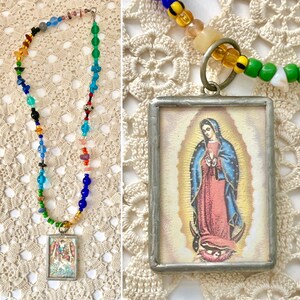 May include: A colorful beaded necklace with a silver framed pendant featuring an image of the Virgin Mary. The pendant is surrounded by a halo of light.
