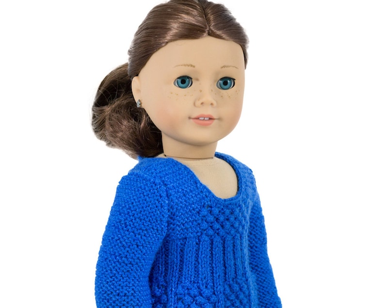 May include: A blue knitted sweater with a textured design. The sweater has a scoop neck and long sleeves.