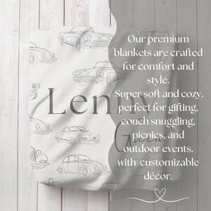 May include: A white blanket featuring a pattern of vintage car illustrations in gray. The blanket has the name "Len" printed on it. Text on the blanket reads "Our premium blankets are crafted for comfort and style."