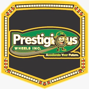 May include: A championship-style belt featuring a central black shield with a green oval logo reading Prestigious Wheels Inc. and a cartoon tire character. The side plates display the text Accelerate Your Future and a matching tire character.
