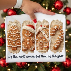 May include: White Christmas-themed fabric featuring four gingerbread-style designs: a tree, a gingerbread man, a house, and a candy cane. The phrase "it's the most wonderful time of the year" is printed below the designs.