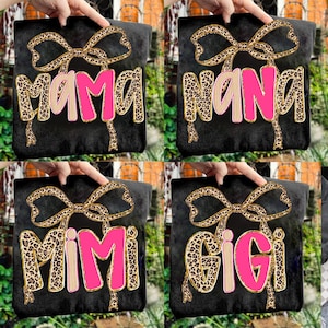 May include: Four black decorative pillows with text in a leopard print font and pink accents. The pillows say "MAMA", "NANA", "MIMI", and "GIGI". Each pillow has a leopard print bow at the top.