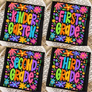 May include: Four black square designs with colorful floral borders and grade level text: "KINDERGARTEN", "FIRST GRADE", "SECOND GRADE", and "THIRD GRADE". Each design features bright, bold lettering in rainbow colors.