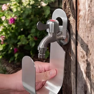 May include: A stainless steel faucet holder with a curved design. The holder is attached to a wooden surface and has a small, round handle. The holder is designed to hold a faucet in place.