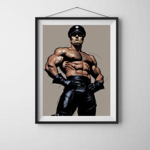 May include: Framed art print of a muscular figure in a black leather cap, gloves, and pants. The artwork features a tan background and a black frame, creating a bold and striking visual statement. The figure is posed with hands on hips.