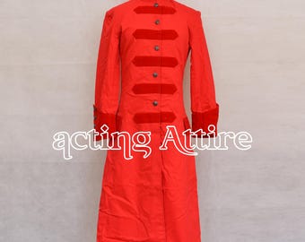 May include: A bright red long coat with a high collar and dark buttons. The coat features red velvet accents on the chest and cuffs. The text "acting Attire" is visible at the bottom.