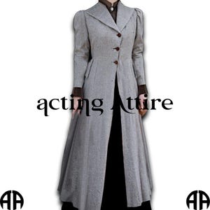 May include: A long, gray coat with a tailored fit, featuring a notched collar and button closure. The coat has long sleeves with brown cuffs and a split front. The text "acting attire" is printed on the coat.