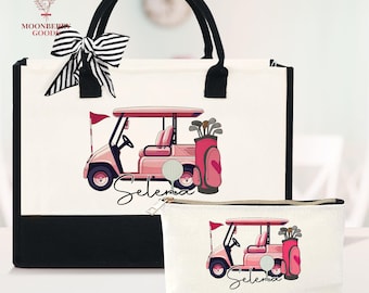 May include: A white tote bag and matching cosmetic bag with a black base and handles. Both bags feature a pink golf cart design with the name "Selena" in script. A black and white striped bow adorns the tote bag.