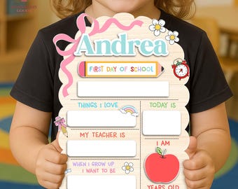 May include: A wooden first day of school sign with the name "Andrea" in blue. The sign includes spaces for "Things I Love," "Today Is," "My Teacher Is," and "I Am" with a red apple graphic. A pink ribbon and flowers decorate the top.