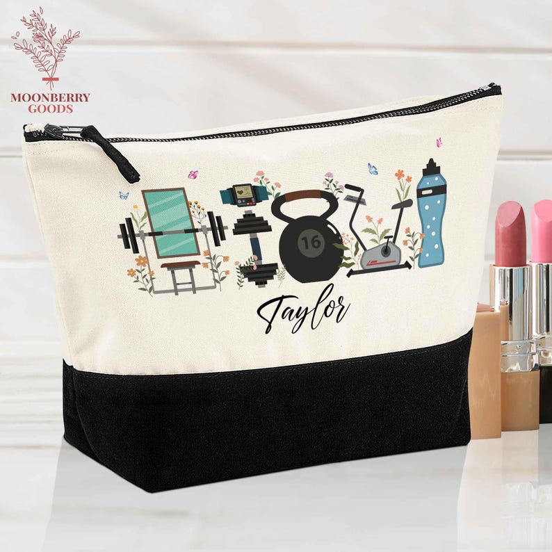 May include: Cream-colored cosmetic bag with a black base and zipper. The bag features a fitness-themed design with illustrations of weights, a kettlebell, exercise bike, and water bottle. The name "Taylor" is written in cursive.