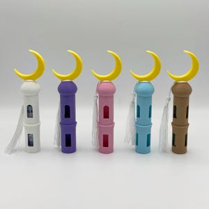 May include: Five decorative minaret towers with crescent moon tops. The towers are in white, purple, pink, blue, and brown.
