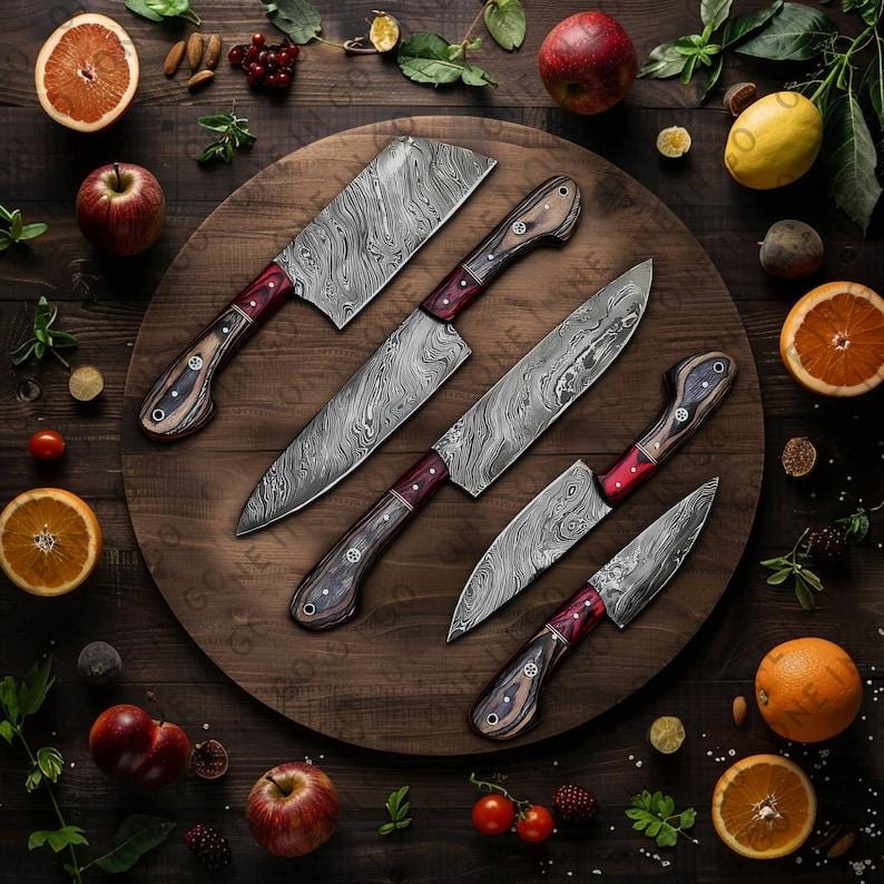 May include: Set of five kitchen knives with Damascus steel blades and wooden handles with red accents. The knives are arranged on a wooden cutting board.