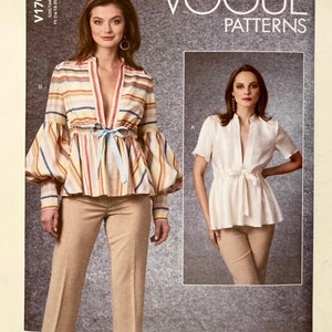 May include: Vogue Patterns sewing pattern for two blouses, one with long sleeves and a striped pattern, and the other with short sleeves and a solid white fabric. Both blouses feature a V-neckline and a tie at the waist.