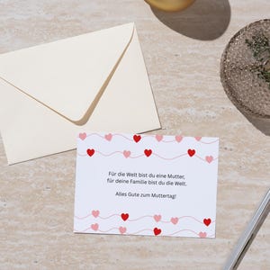 May include: A white card with a pink and red heart pattern and the text "For the world you are a mother, for your family you are the world. Happy Mother's Day!"