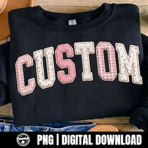 May include: A navy blue sweatshirt featuring the word "CUSTOM" in a patchwork design. The letters are in pink polka dot, gingham, and floral patterns, with white daisy accents. The image also includes the text "PNG | DIGITAL DOWNLOAD".