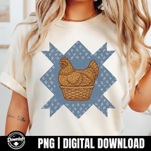 May include: Cream-colored t-shirt featuring a brown hen in a woven basket, set against a blue starburst pattern with white floral accents. The text "PNG | DIGITAL DOWNLOAD" is at the bottom. The shirt has rolled-up sleeves.