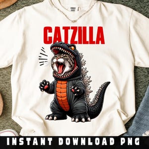 May include: White t-shirt with the word "CATZILLA" in red block letters. The shirt features a cartoon illustration of a cat dressed as Godzilla, with an open mouth and a black and gray costume. The words "INSTANT DOWNLOAD PNG" are at the bottom.