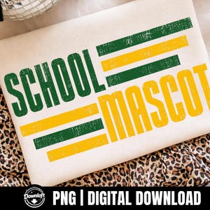 May include: A white t-shirt featuring the word SCHOOL in distressed green letters and the word MASCOT in distressed yellow letters. The design includes horizontal green and yellow stripes with a weathered texture, creating a vintage aesthetic.