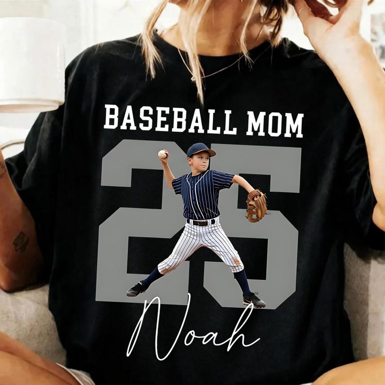 A digital download mockup featuring a white t-shirt with a vintage sketch of a youth baseball player swinging a bat, layered over a large custom grey block number 55, with Baseball Mom at the top and a custom name at the bottom.
