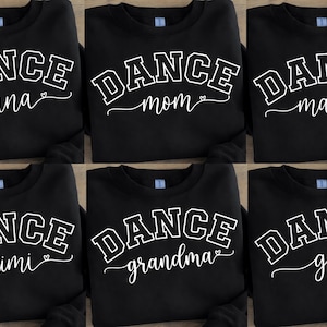 May include: Black sweatshirts with white text that reads "DANCE" in a collegiate font, with names like "nana", "mom", "mama", "mimi", "grandma", and "gigi" in a script font below. Each design includes a small heart.