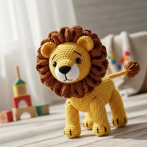 May include: A handmade crochet lion toy in shades of yellow and brown. The lion has a fluffy brown mane, a white muzzle, and black eyes. The toy is standing on all fours, with a tail and black claws. A children's toy.