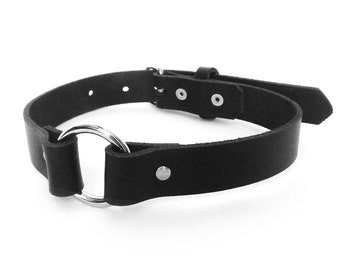 May include: Black leather choker with a silver ring and buckle closure.