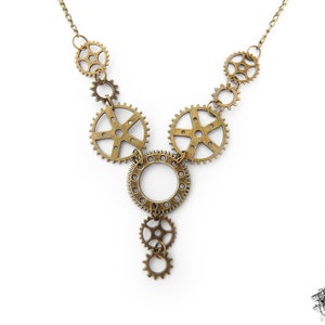 Steampunk gear necklace featuring intricately detailed bronze-tone gears and cogs. This handmade necklace showcases a vintage industrial aesthetic, perfect for steampunk enthusiasts and mechanical-inspired fashion lovers. Lightweight design ensures comfort, while interlocking gears add depth and movement. Ideal for cosplay, themed events, or unique statement accessories. A great gift for fans of quirky, alternative jewelry styles.