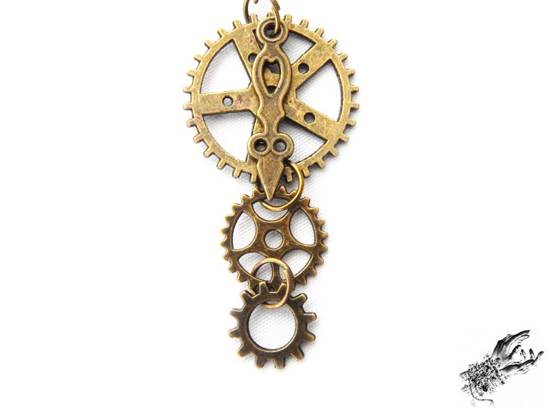 Close-up of Steampunk gear earrings featuring intricately detailed bronze-tone gears and cogs. These handmade dangle earrings showcase a vintage industrial aesthetic, perfect for steampunk enthusiasts and mechanical-inspired fashion lovers. Lightweight design ensures comfort, while interlocking gears add depth and movement. Ideal for cosplay, themed events, or unique statement accessories. A great gift for fans of quirky, alternative jewelry styles.