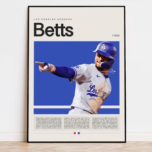 May include: A blue and white baseball poster featuring a baseball player wearing a blue and white baseball uniform and a blue baseball cap with the Los Angeles Dodgers logo. The poster has the text "Los Angeles Dodgers" and "Betts" in black text. The poster also has the text "/1992" in black text.