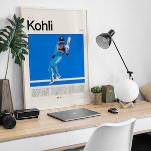 Pu&ograve; includere: Un poster incorniciato con uno sfondo blu che presenta una foto di un uomo con una divisa blu e bianca che gioca a cricket. Il poster ha il testo "INDIA Kohli /1988" nella parte superiore.
