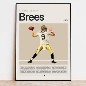 May include: A poster featuring a black and white illustration of a football player throwing a football. The poster has the text "New Orleans Saints" and "Brees" in bold black text. The player is wearing a white jersey with the number 9 and gold pants. The poster also has the text "1979" in the top right corner.