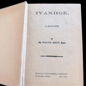 May include: The title page of a book titled IVANHOE. A ROMANCE by SIR WALTER SCOTT, BART. The text includes MCLEAN PUBLISHING COMPANY, 88 WALKER STREET, NEW YORK. The page is light beige with black serif typography and a horizontal line separator.