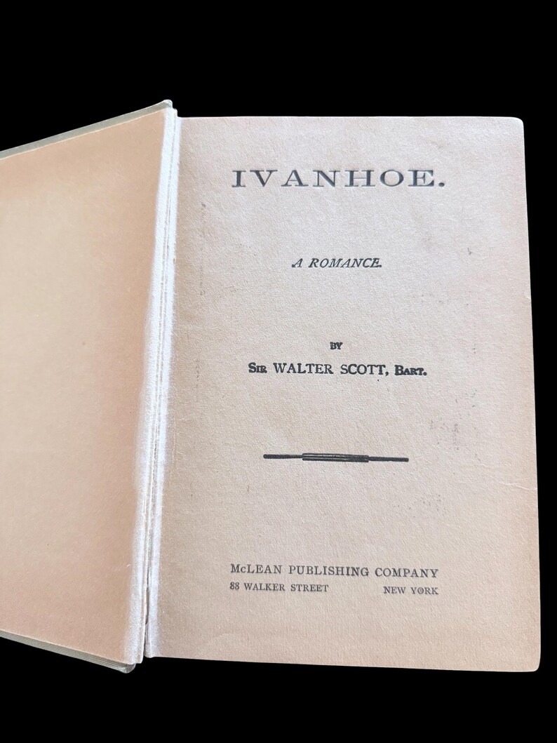 May include: The title page of a book titled IVANHOE. A ROMANCE by SIR WALTER SCOTT, BART. The text includes MCLEAN PUBLISHING COMPANY, 88 WALKER STREET, NEW YORK. The page is light beige with black serif typography and a horizontal line separator.