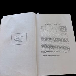 May include: An open book page displaying an Acknowledgment section with black printed text on a white background. A copyright notice box is visible on the left page, dated August 1911, by Elbert W. Reynolds, and Harold Bell Wright.
