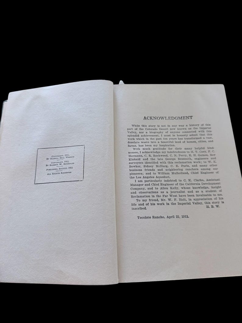 May include: An open book page displaying an Acknowledgment section with black printed text on a white background. A copyright notice box is visible on the left page, dated August 1911, by Elbert W. Reynolds, and Harold Bell Wright.