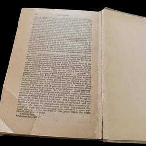 May include: An open antique book page with aged, off-white paper and black printed text. The header reads IVANHOE. The text discusses literary themes and character fates. The bottom left corner shows the text ABBOTSFORD, 1st September, 1830.