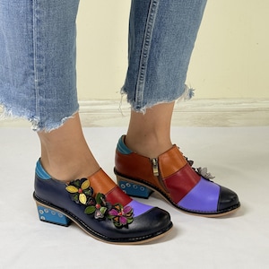 Puede incluir: Zapatos de cuero multicolores con una cremallera lateral y adornos florales. Los zapatos tienen un tac&oacute;n de bloque y una puntera redonda.