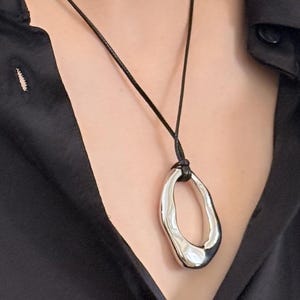 Silver Abstract Pendant Necklace, Sculptural Open Charm on Black Cord, Modernist Minimalist Jewelry, Geometric Statement Necklace for Women