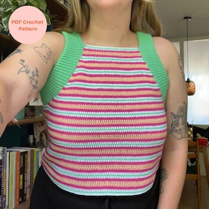 May include: A striped crochet top in pink, light green, and peach. The top features a square neckline and wide straps in a solid light green. The text "PDF Crochet Pattern" is in a pink circle in the upper left corner. The top is handmade.