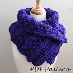 May include: A purple knitted cowl neck scarf with a textured stitch pattern. The scarf is displayed on a white mannequin. The text "PDF Pattern" is visible at the bottom of the image.