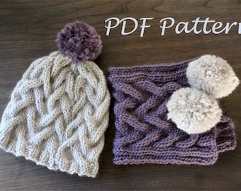 May include: A PDF pattern for a knitted hat and scarf set. The hat is beige with a purple pompom and the scarf is purple with two white pompoms.