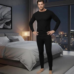 May include: A solid black long-sleeve thermal shirt and matching black thermal pants set. The shirt features a crew neckline and fitted cuffs, while the pants have a slim-fit design with ribbed ankle cuffs, creating a cohesive base layer.