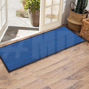 May include: A blue doormat with a herringbone pattern. The doormat has a black border and is placed on a wooden floor.