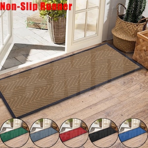 May include: A brown doormat with a chevron pattern and black edging. The doormat is labeled "Non-Slip Runner".
