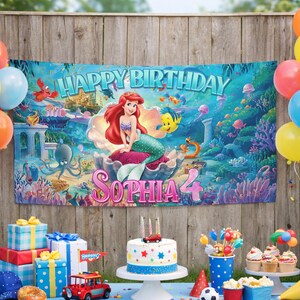 May include: A rectangular birthday banner featuring an underwater scene with Ariel from The Little Mermaid, the text HAPPY BIRTHDAY, and the name SOPHIA with the number 4. The background displays coral, sea creatures, and a castle.
